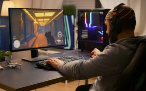 videogamer winning first person shooter tournament using rgb keyboard professional headphones pro player man talking with other players online game competition powerful computer